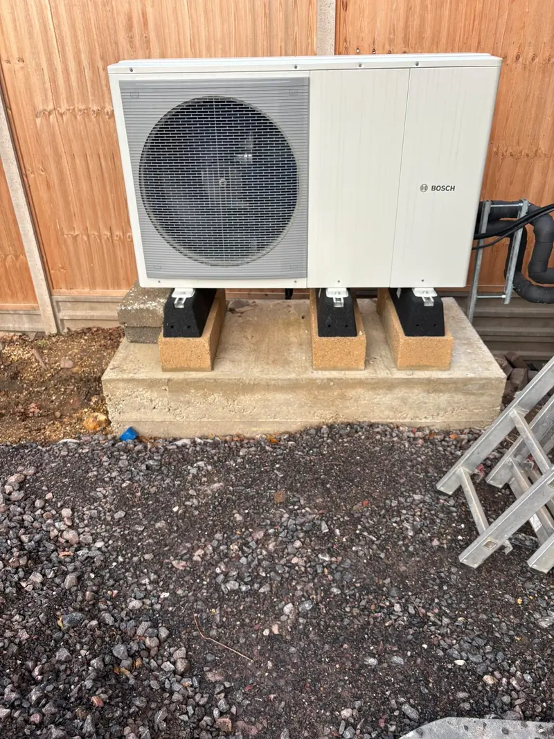 Air source heat pump installation outside a home by C Hobbs Plumbing and Heating in Luton