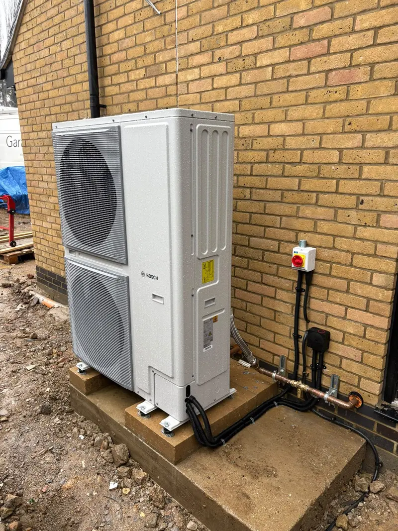 Air source heat pump installation outside a home by C Hobbs Plumbing and Heating in Milton Keynes