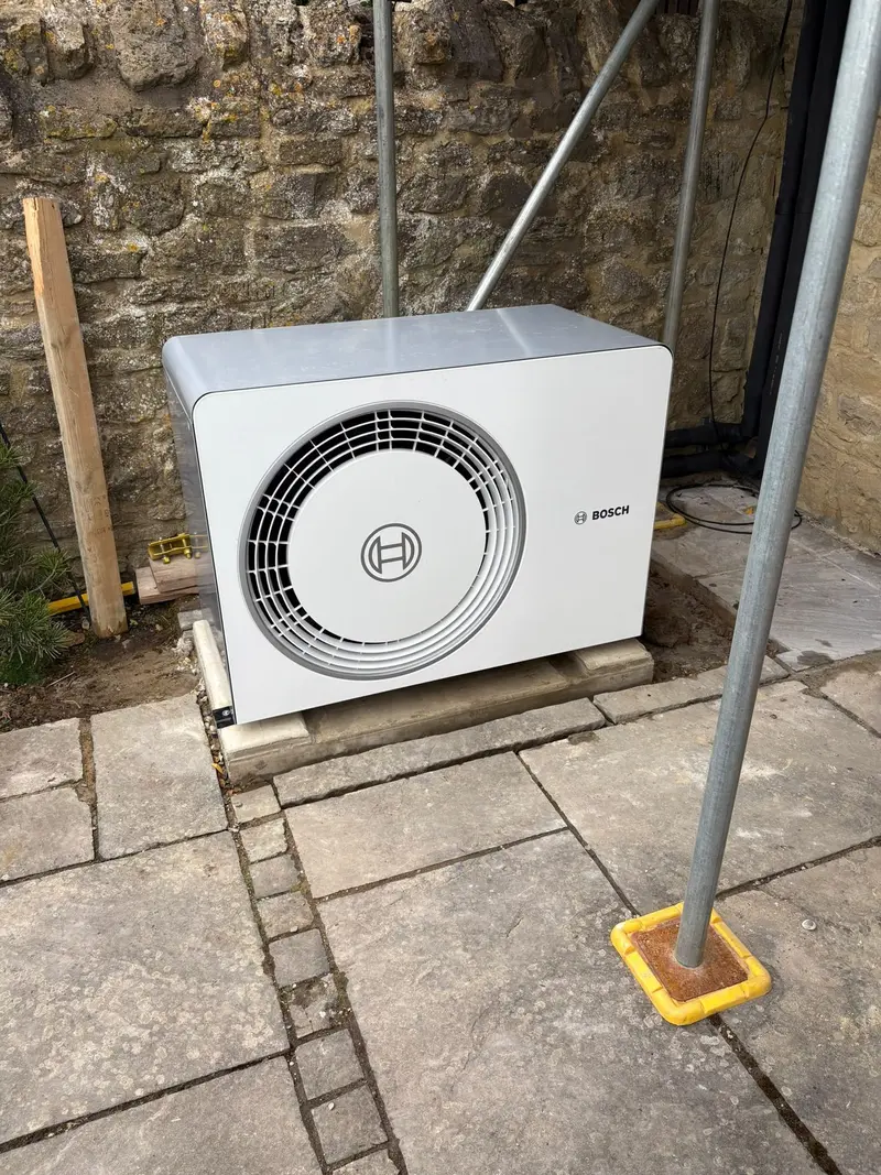 Air source heat pump installation outside a home by C Hobbs Plumbing and Heating in Bedfordshire