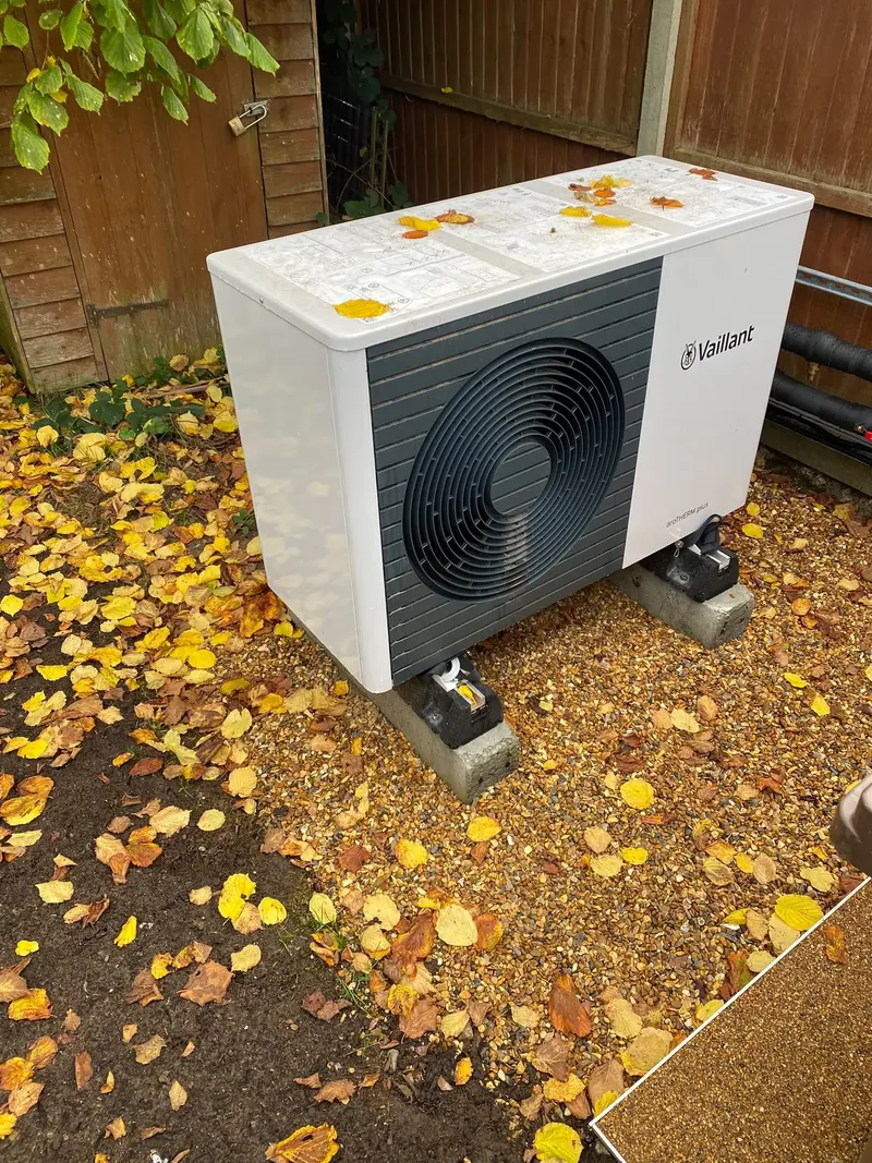 Air source heat pump installation outside a home by C Hobbs Plumbing and Heating in Bedford