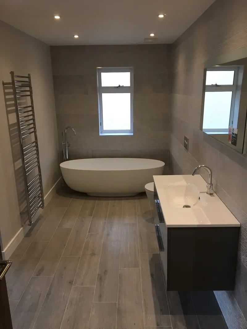 Completed bathroom installation by C Hobbs Plumbing and Heating in Bedford: tiling, sanitaryware and fitted brassware