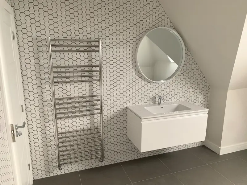 Completed bathroom installation by C Hobbs Plumbing and Heating in Bedford: tiling, sanitaryware and fitted brassware