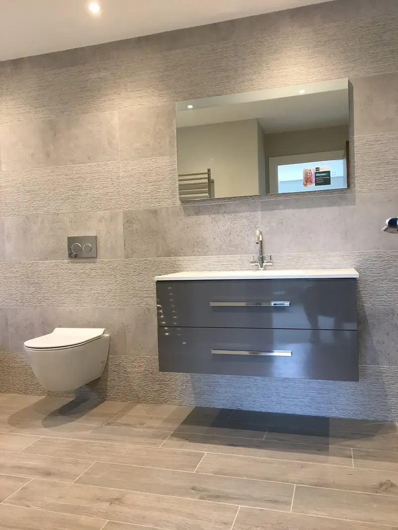 Completed bathroom installation by C Hobbs Plumbing and Heating in St Albans: tiling, sanitaryware and fitted brassware