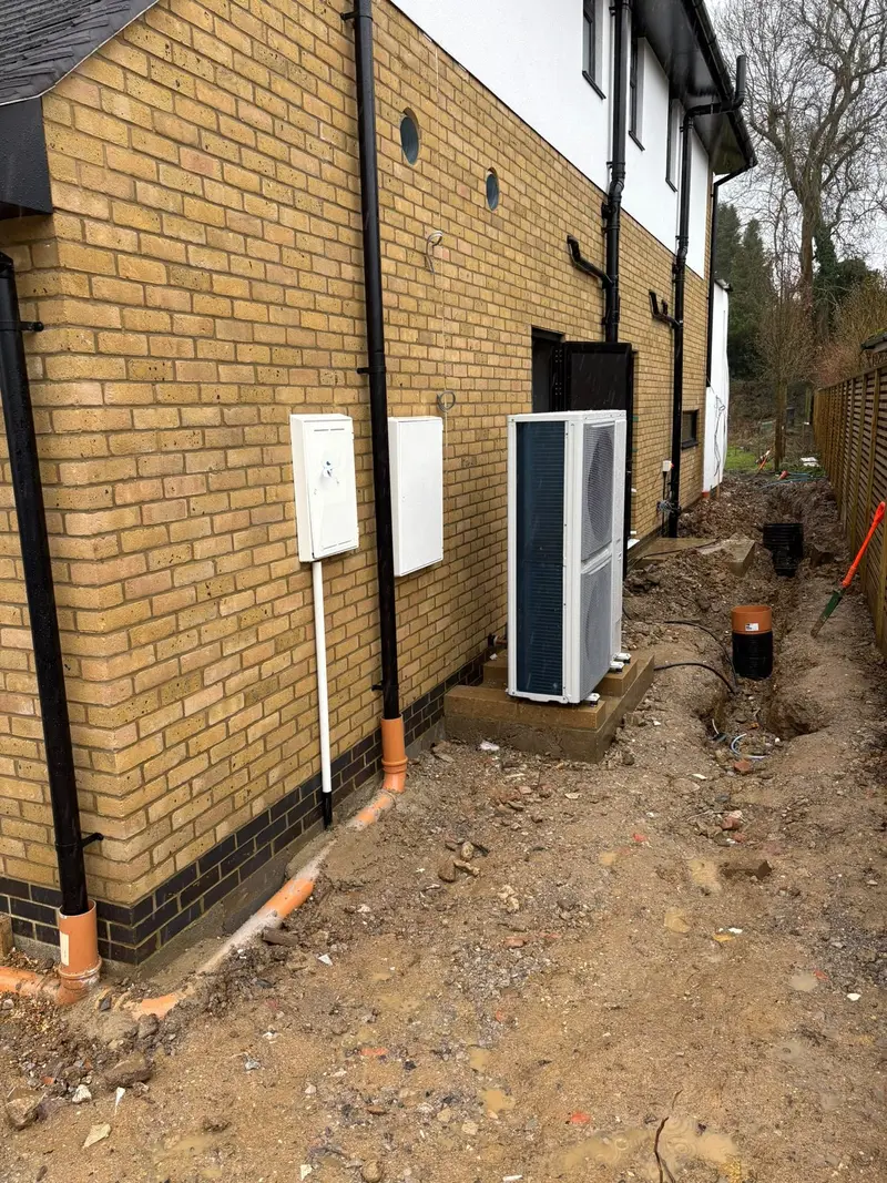 Air source heat pump installation outside a home by C Hobbs Plumbing and Heating in Dunstable