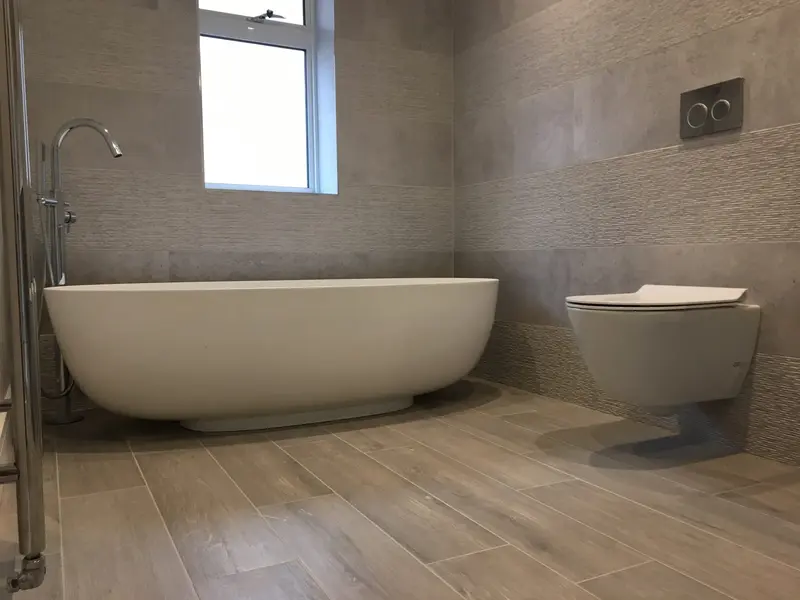 Completed bathroom installation by C Hobbs Plumbing and Heating in St Albans: tiling, sanitaryware and fitted brassware