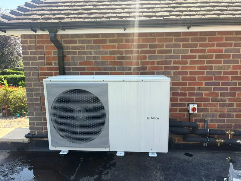 Air source heat pump installation outside a home by C Hobbs Plumbing and Heating in Harpenden