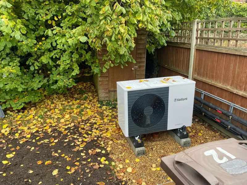 Vaillant air source heat pump installed on concrete plinths in a garden by C Hobbs Plumbing and Heating